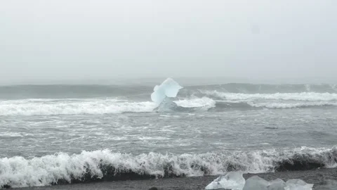 Glacial Ice Structure Moving in Ocean Waves at Diamond Beach in Iceland Stock Footage 339952753
