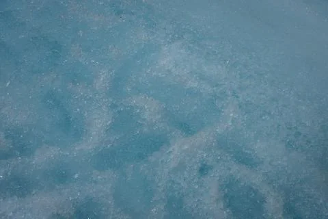 Glacial Ice: A study in cool tones, shapes and textures on a frozen surface. Stock Photos
