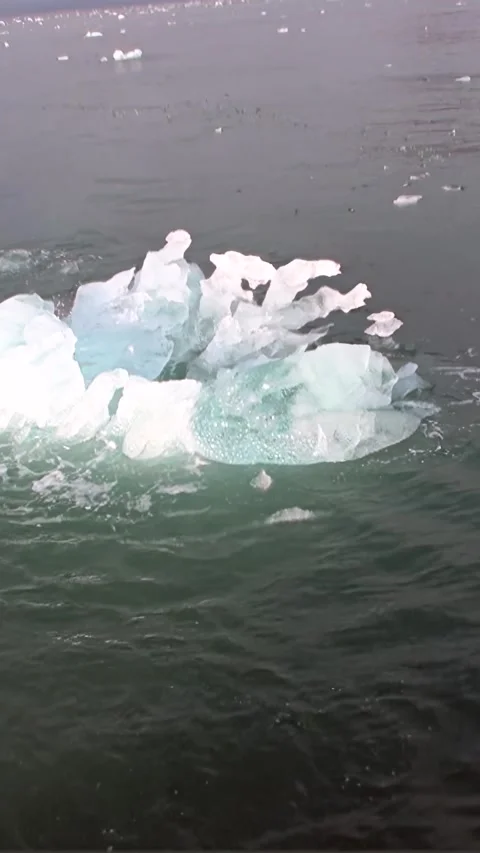 Glacial Ice Yields to Arctic Waters in a Delicate Svalbard Dance Stock Footage 340483323