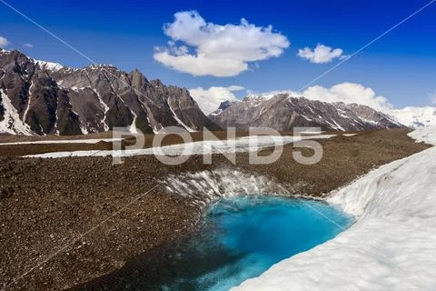 Glacial lake on Kennicott Glacier, with Wrangell Mountains in background, in sum Stock Photos