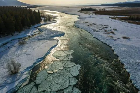 Glacial Melt River Flowing Through Cracked Ice Landscape - Aerial View Stock Photos