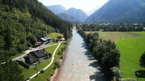 Glacial mountain river with rapids and rocks running through a green valley Stock Footage 250524783