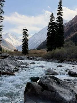 Glacial River Flowing Through Alpine Valley Stock Photos