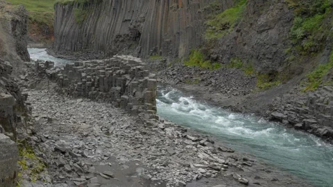Glacial River Flowing Through Basalt Column Formations of Stuðlagil Canyon in Stock Footage 339876947