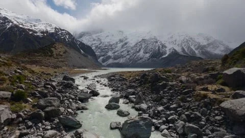 Glacial River Flowing Through Hooker Valley with Snowy Mountains, New Zealand Stock Footage 330682477