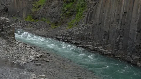 Glacial River Flowing Through Stuðlagil Canyon Basalt Columns in Iceland Stock Footage 339874913
