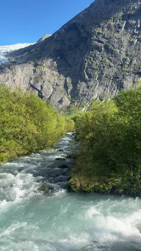Glacial River Flowing Through Valley With Green Trees And Mountains Norway Stock-Footage 346970033