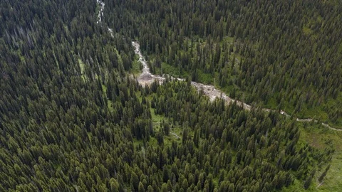 Glacial river following down the Mountain 4K Aerial Drone Footage Stock Footage 125282247