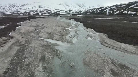 Glacial River with Snowy Mountains, Cloudy Day, Drone Shot Stock Footage 169554413
