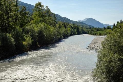Glacial river winds through a dramatic mountain landscape Stock Photos