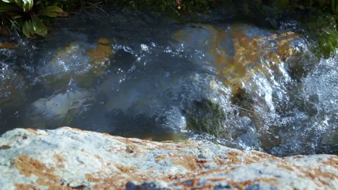 Glacial water flows in a brook high in the mountains 4 Stock-Footage 103963476