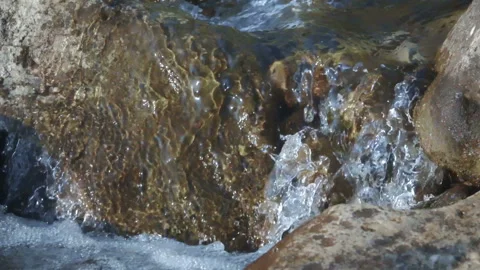 Glacial water flows from the mountains through the rocks 4 Video stock 103968937