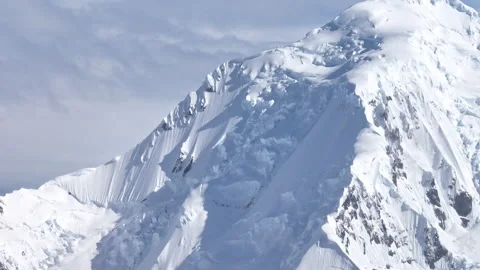 Glaciated mountain peak covered in deep snow Stock Footage 337951576