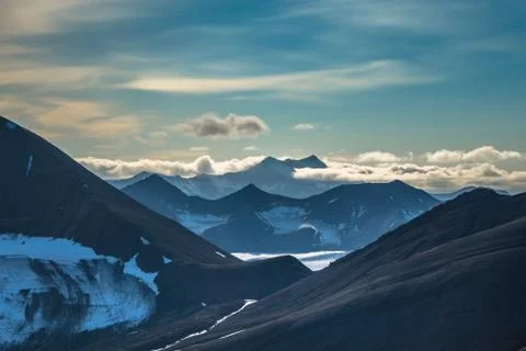 Glacier and mountain range under the clouds Stock Photos