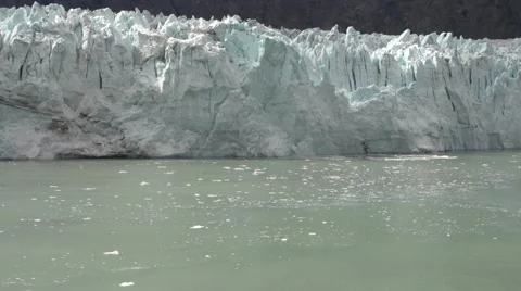 Glacier breaking and falling in water in Alaska from cruise ship Stock Footage 66561374