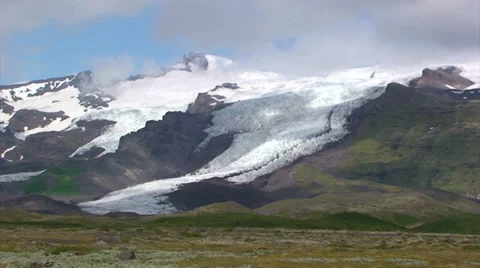 Glacier descends down the valley, moving clouds time lapse Stock Footage 37779179