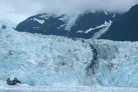 Glacier with dramatic mountain backdrop 写真素材