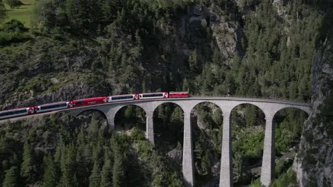 The Glacier Express train passes over the Landwasser Viaduct in Stock Footage 203999037