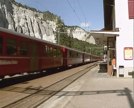 Glacier Express train passing Versam station in the  Ruinaulta or Rhine Canyon Stock Footage 43831403