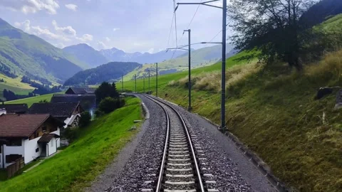 Glacier Express Train with Railroad Tracks and Beautiful Mountainscape 스톡 동영상 284019076