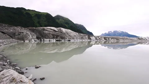 Glacier front with developing meltwater lake under overcast sky Stock Footage 332186827