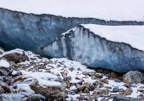 Glacier high in the mountains. A high layer of ice permafrost. Stock Photos