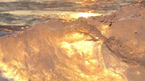 Glacier Ice Berg Close Up Diamond Beach Iceland. Warm Sunrise Ice Melting Ocean Stock Footage 256693732