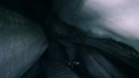 Glacier ice cave - exploring icy darkness of tunnel interior path 스톡 동영상 153320621