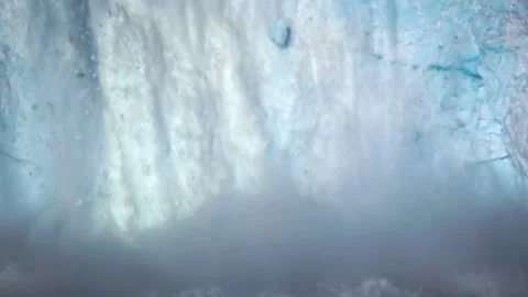 Glacier Ice Collapse Into Ocean Water. A large mass of ice falls into the water. Stock Footage 171813666