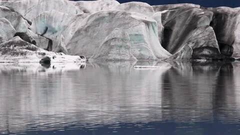 Glacier ice dissolving into lake with subtle motion Stock Footage 332186894