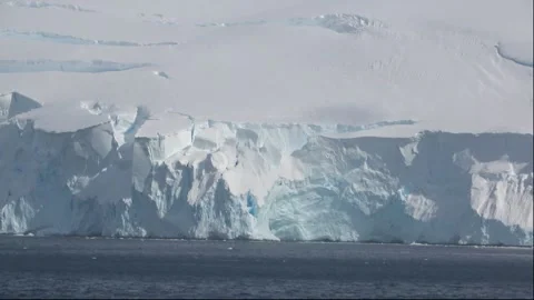 Glacier ice wall coastline ship panning Antarctica, 4K Stock Footage 332393624