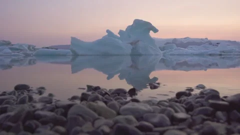 Glacier Lagoon Iceland Rack Focus from Pebbles in Foreground to Icebergs Stock Footage 256696520