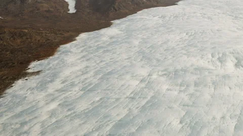 Glacier landscape showing ice surface and rocky terrain in daytime Stock Footage 344399525