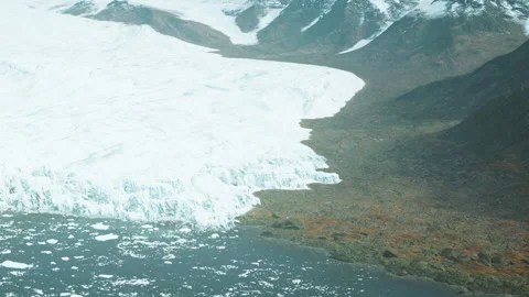 Glacier meets land at the edge of a remote landscape in a cold region Stock Footage 340624717