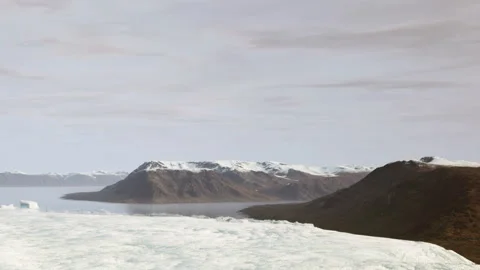 Glacier meets the ocean with mountains in the background near Iceland Stock Footage 344131277
