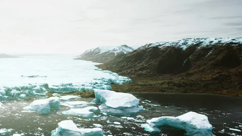 Glacier melting icebergs float in cold water under cloudy sky in Iceland Stock Footage 339501361
