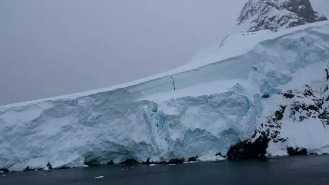 Glacier wall ice cliff pan Antarctica, 4K Stock Footage 332393644