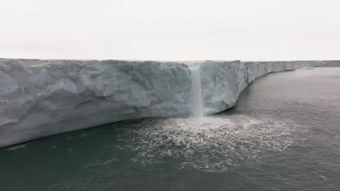 Glacier Waterfall Drone Shot 4k Melting Arctic Ice Flowing into Ocean Stock Footage 338263556