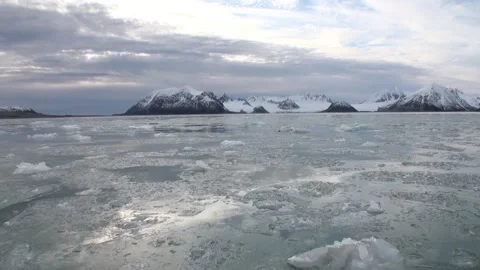 Glacier Waters of Svalbard Move Toward Snowy Arctic Mountains Stock Footage 320797672