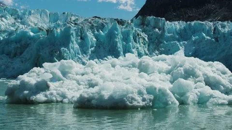 Glaciers calving. Ice cubes fall into the river forming numerous ice floes. Stock Footage 238521117
