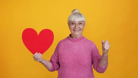Glad cheerful granny receive valentine gift invitation party rejoice admire Stock Footage 162032753