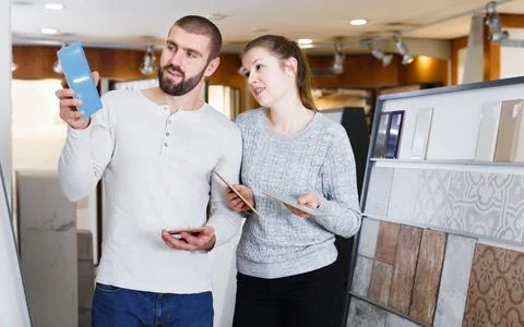 Glad couple looking sample of ceramic tile Stock Photos