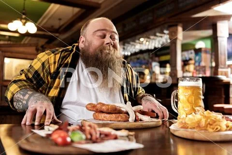 Glad fat male snuffing meal Stock Photos