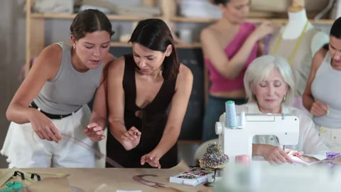 Glad female students are engaged in different activities during sewing class in Stock Footage 319494186