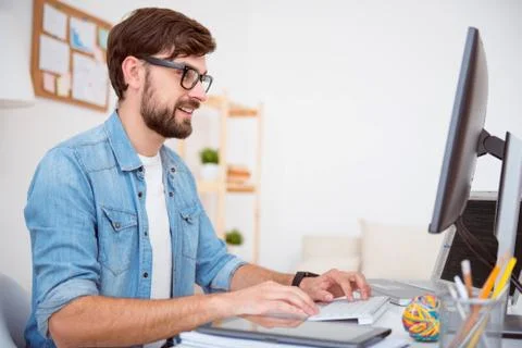 Glad man working on computer 写真素材