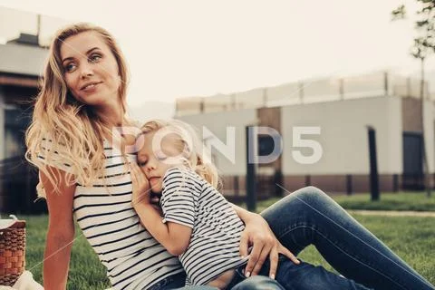 Glad woman with calm daughter relaxing outdoor Stock Photos