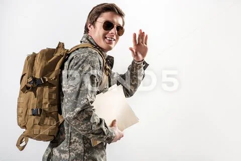 Glad young male soldier waving goodbye Stock Photos