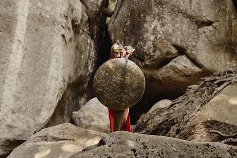 Gladiator covering with shield while attacking Stock Photos