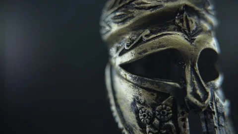 Gladiator helmet in macro view, rotating with moisture and dramatic studio Stock Footage 334251175