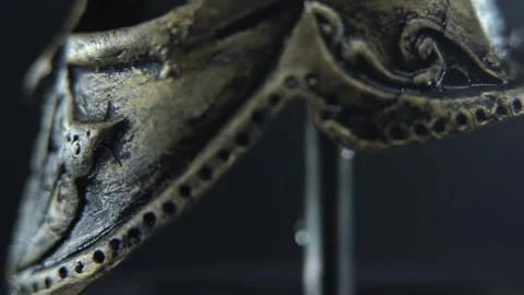 Gladiator helmet rotating smoothly on stand, wet bronze surface with cinematic Stock Footage 334162046